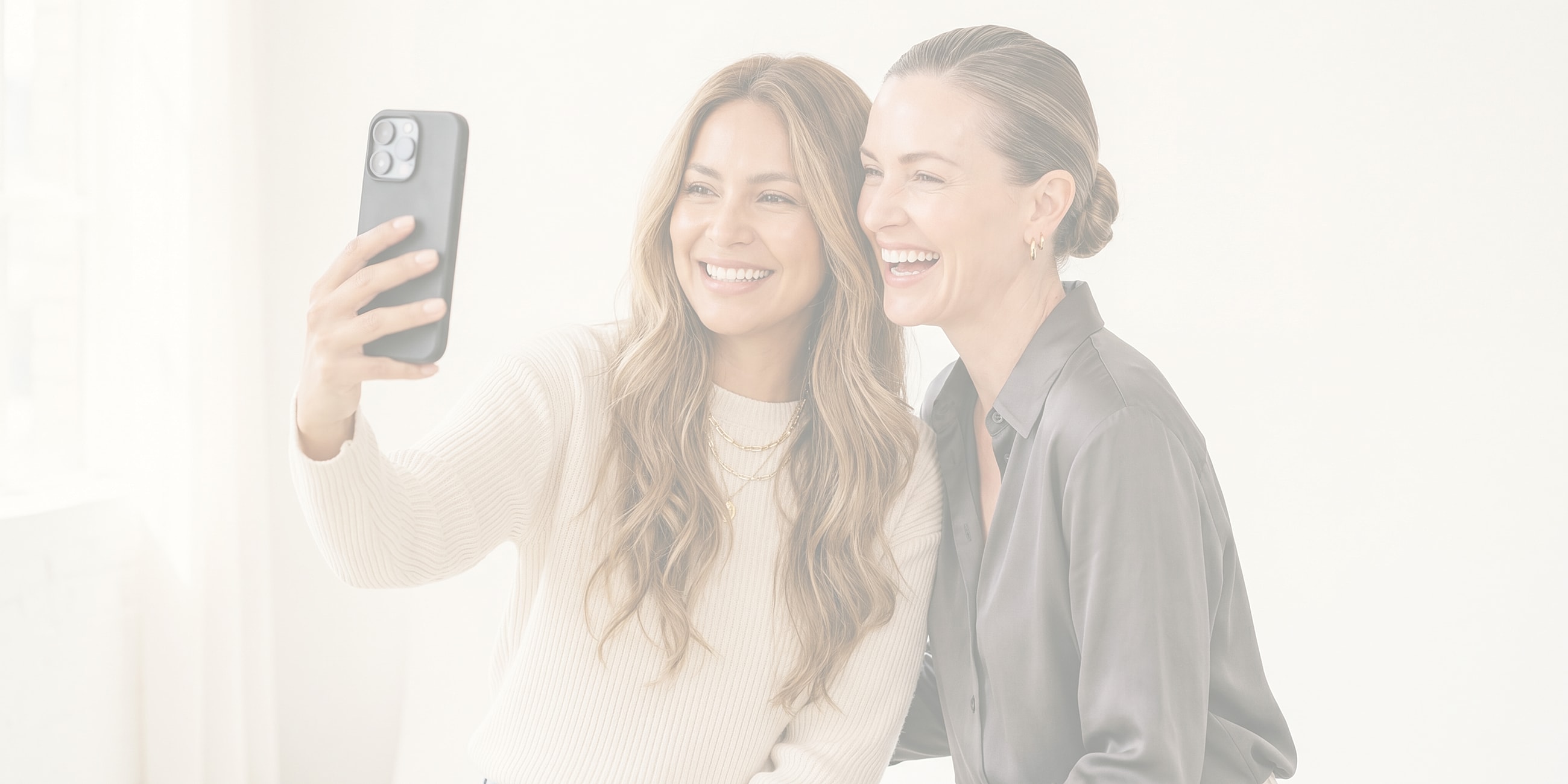 Lafayette facial plastic surgery models taking a selfie together, smiling.