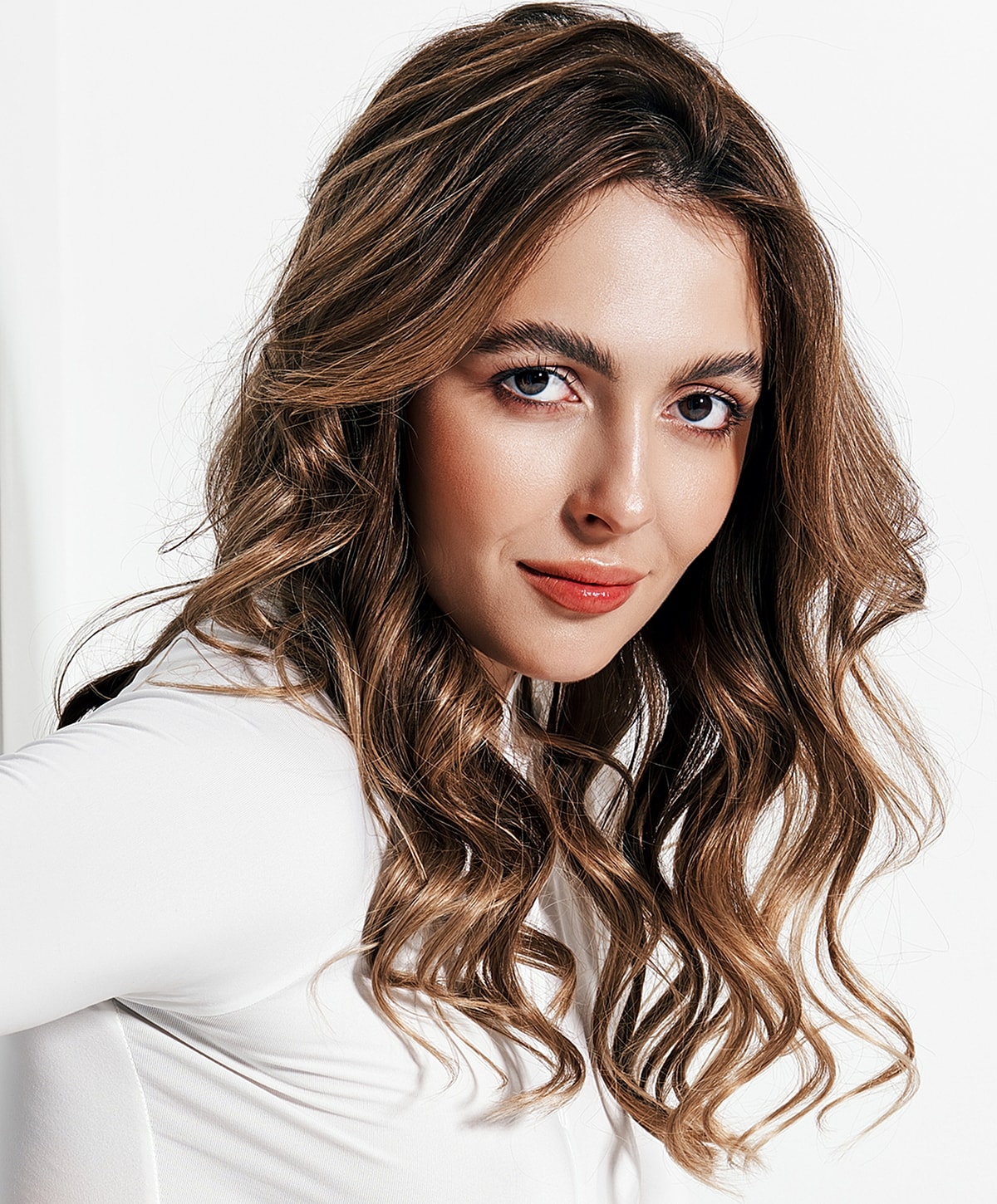 Young Lafayette CO2 Laser model with wavy hair and natural makeup.