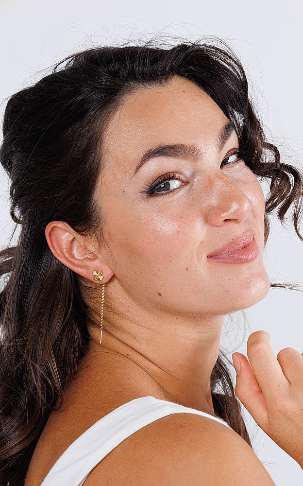 Lafayette facial plastic surgery model smiling with earrings and curly hair.