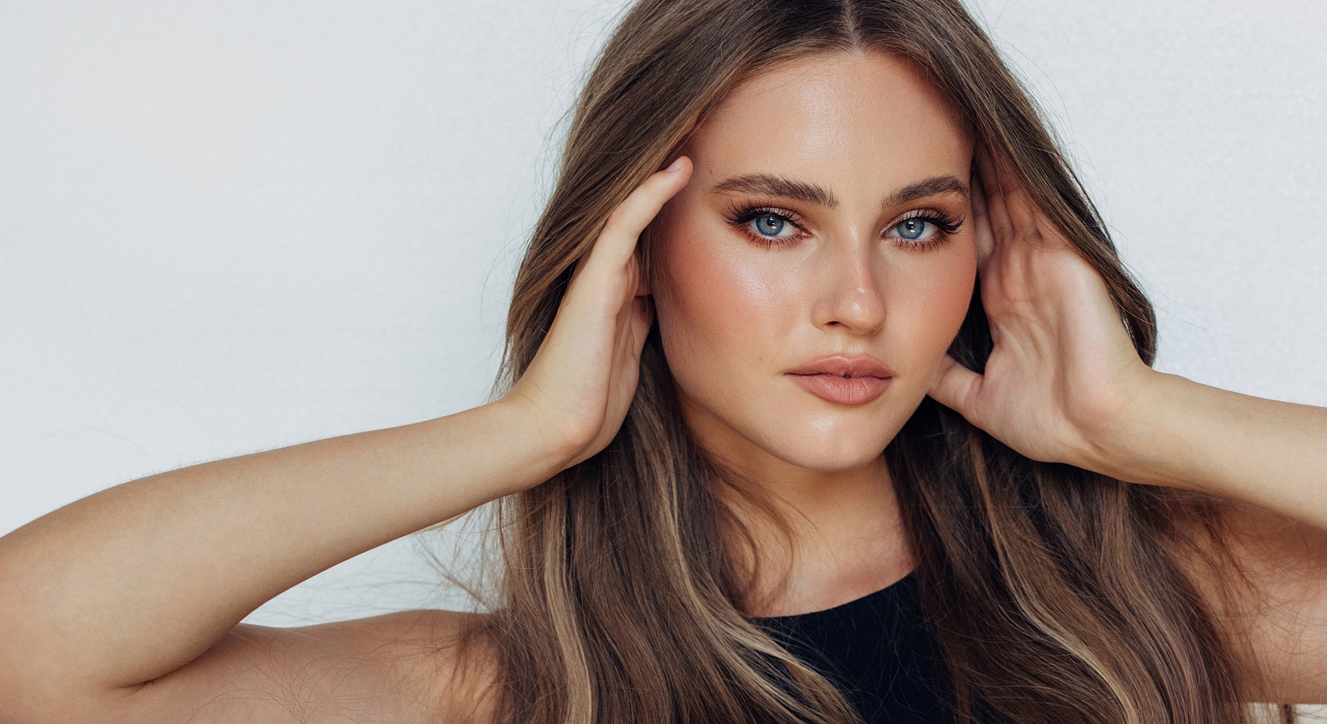 Lafayette Dermal Fillers model with long hair and natural makeup.